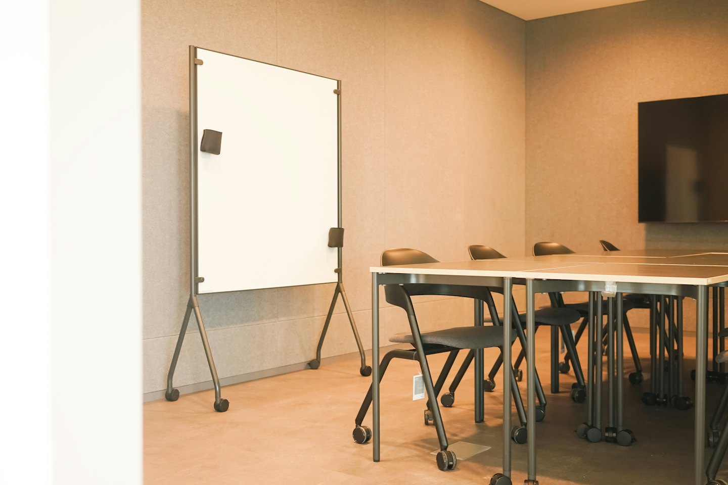 Modern meeting room with a conference table and whiteboard.